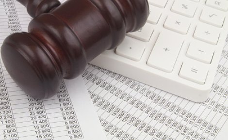 Gavel with calculator and spreadsheet